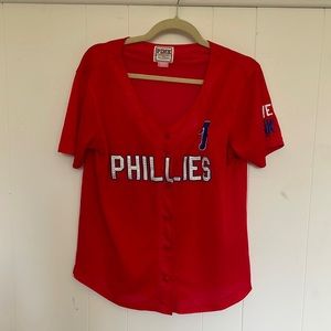 A medium red Phillies jersey from PINK. Size medium. Cute for baseball season